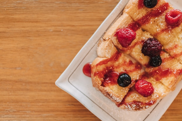 Postre de pan tostado con cereza y bayas