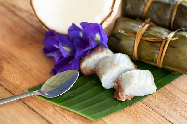 Foto postre tradicional tailandés arroz con plátanos (khao tom mat) sobre fondo de madera