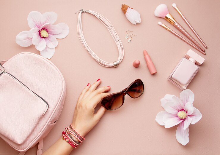 Foto postura plana com acessórios de mulher-de-rosa com mochila e mulher mão segurando os óculos de sol. tendências de moda de verão, ideia de compras