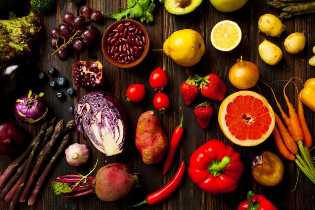 Postura plana de um grande grupo de legumes frescos e frutas em fundo de madeira. Plantas orgânicas de alta qualidade.