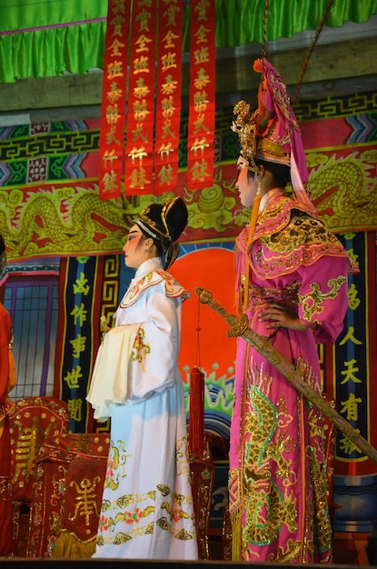 Povo tailandês de ascendência chinesa atuando tocando presente ópera clássica contemporânea chinesa tradicional para mostrar a população local no festival de feliz ano novo na cidade em 13 de março de 2011 em Bangkok Tailândia