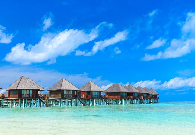 Praia com bangalôs aquáticos em MaldivesxAxA