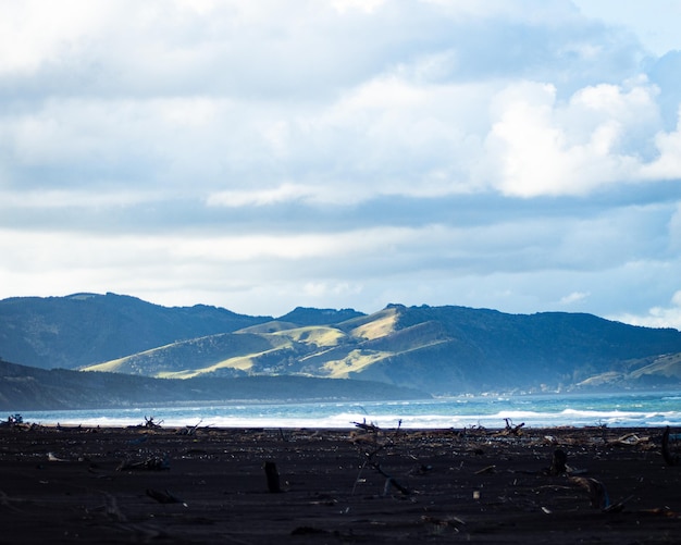 Foto praia com montanhas distantes