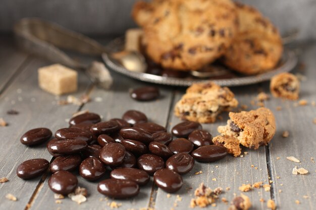 Praline mit Schokoladensplitterplätzchen auf hölzernem Hintergrund