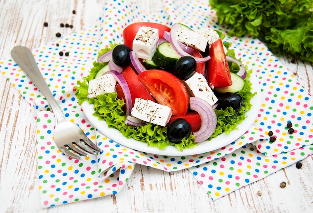 Prato com salada grega fresca em fundo de madeira