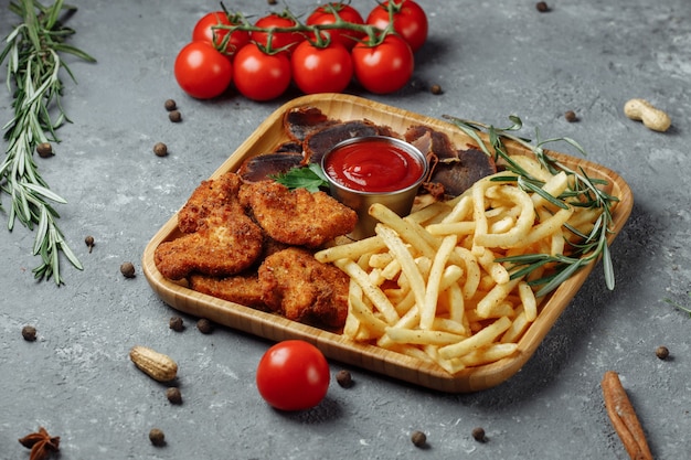 Prato com snacks nuggets de frango à milanesa, batata frita e jamon