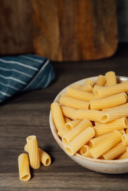 Prato de massa com um punhado de rigatoni cru