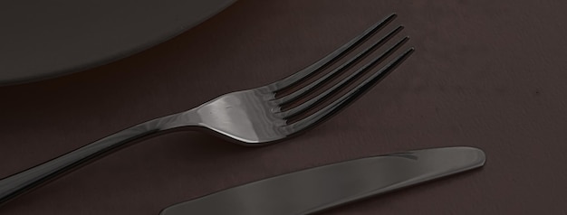 Prato vazio e talheres como maquete em talheres de fundo marrom escuro para decoração de mesa de chef e marca de menu