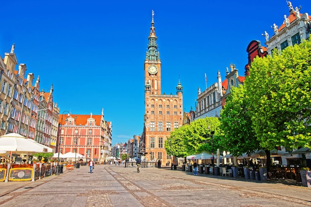 Foto prefeitura principal e praça dlugi targ no centro da cidade velha de gdansk, polônia. pessoas no fundo.