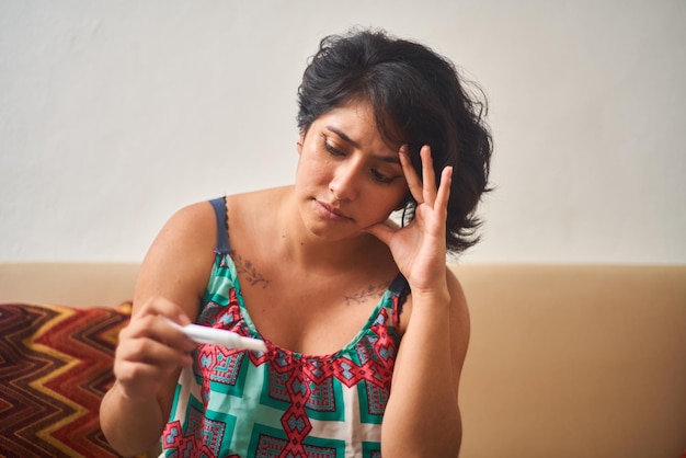 Foto preocupada jovem latina esperando pelo resultado do teste de gravidez maternidade consciente planejamento familiar