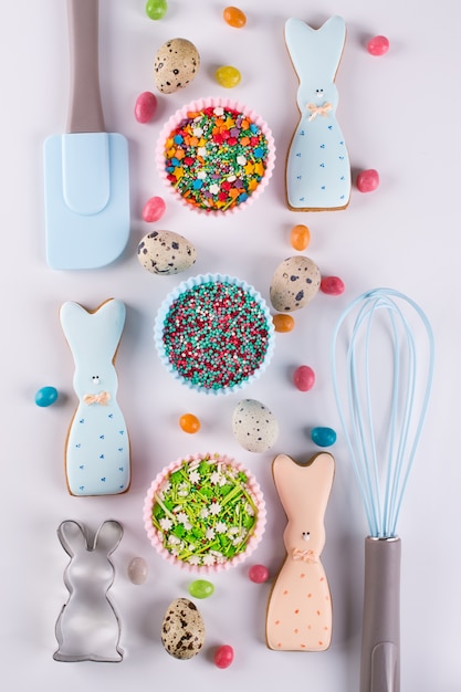 Preparación de galletas de pascua de pan de jengibre. Cortadores de galletas, galletas con forma de conejito divertido y utensilios de cocina.