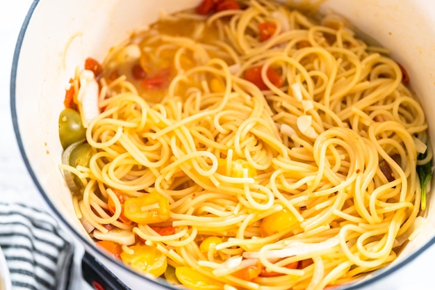 Preparación de pasta en una olla en horno holandés de hierro fundido esmaltado.