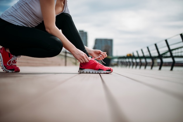 Preparándose para una carrera. Atar cordones de los zapatos.