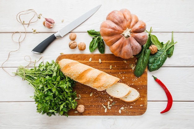 Preparar sándwiches de verduras en casa. Vista superior de la mesa de madera blanca con ingredientes para cocinar tostadas de calabaza