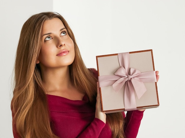 Presente de feriado para casamento de chá de bebê de aniversário ou entrega de assinatura de caixa de beleza de luxo mulher feliz segurando um presente rosa embrulhado