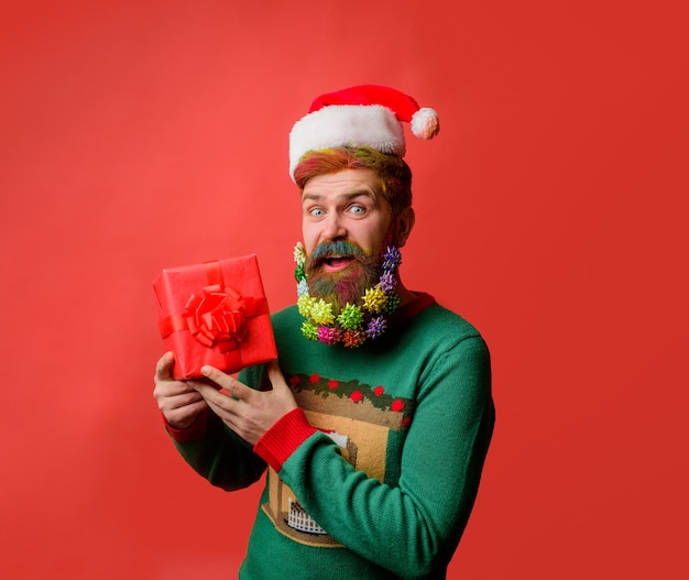 Presente Feliz Navidad Hombre sorprendido con gorro de Papá Noel con caja de regalo Víspera de Año Nuevo Feliz Año Nuevo