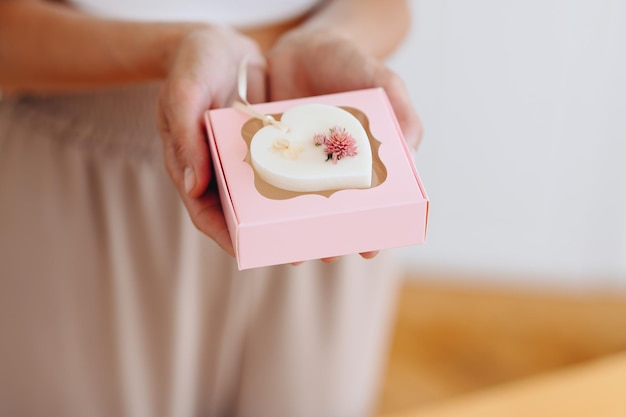 Presente para menina mulher avó em caixa rosa suave mulher segura presente em suas mãos