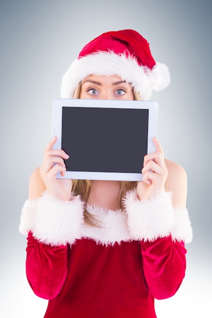 Pretty santa girl holding tablet