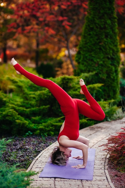 Foto pretty woman haciendo ejercicios de yoga en el parque