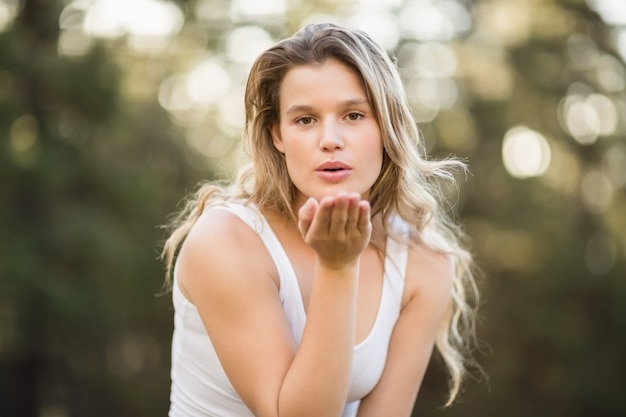 Pretty young jogger blowing kiss