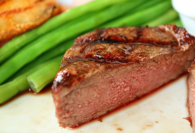 Primer filete mignon a la parrilla mediano cortado por la mitad mostrando una deliciosa textura marrón rosa