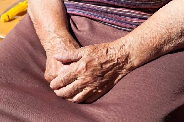 Primer fotografiado de una anciana. manos juntas