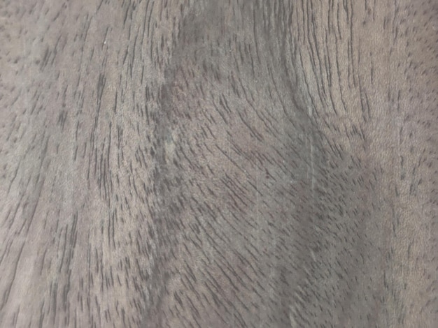 Foto un primer plano de un acabado de grano de madera gris con una mancha oscura.