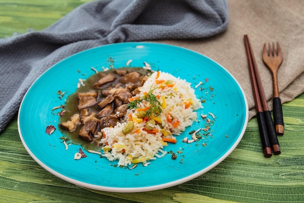 Foto primer plano de arroz y carne servidos en un plato sobre la mesa