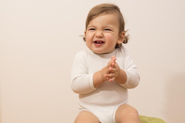 Foto primer plano de un bebé lindo contra un fondo beige