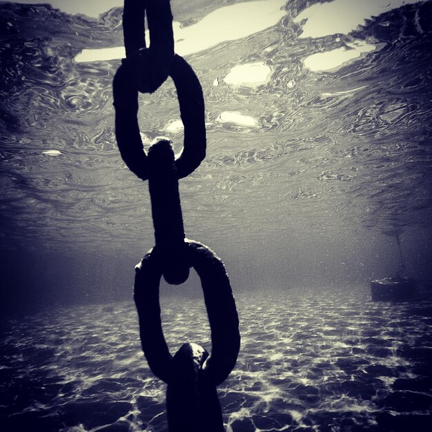 Foto primer plano de una cadena rústica bajo el mar