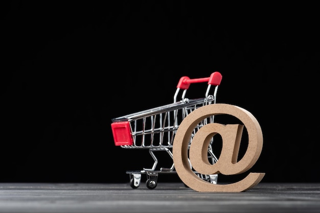 Primer plano del carrito de compras en la mesa contra un fondo negro