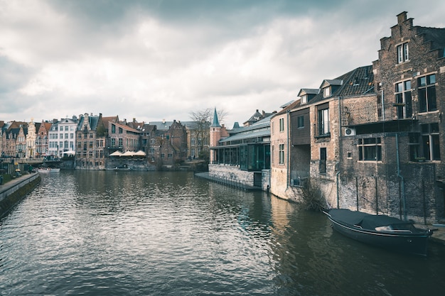 Primer plano de casas multicolores, cafés y canal en Gante, Bélgica