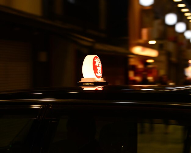 Primer plano de un coche iluminado en la ciudad por la noche