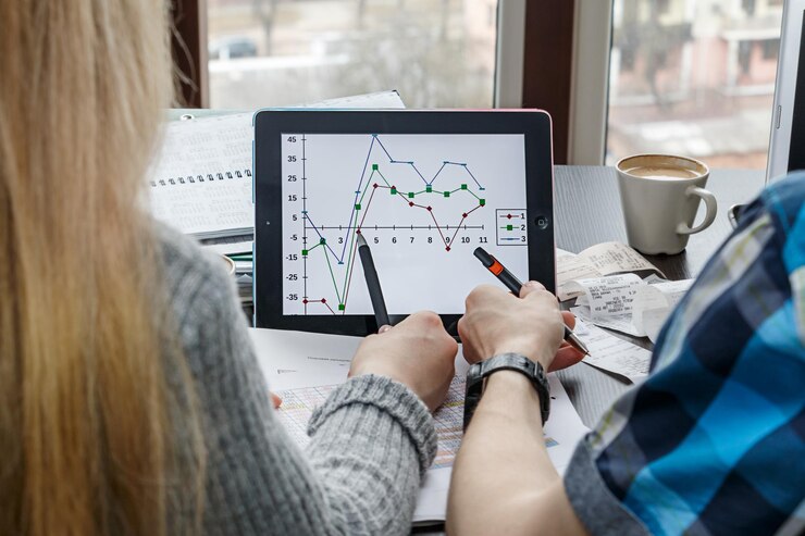 Foto primer plano de colegas discutiendo sobre el gráfico en una tableta digital en la oficina