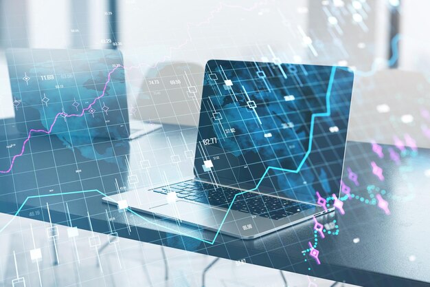 Primer plano de una computadora portátil en el escritorio de la oficina con un gráfico de divisas brillante y una cuadrícula en un fondo borroso Concepto de crecimiento financiero y comercio de acciones Exposición doble