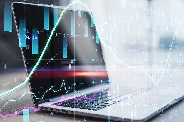 Primer plano de la computadora portátil con un gráfico de forex brillante abstracto sobre fondo borroso con candelabro Invertir comercio y concepto de corredor Doble exposición