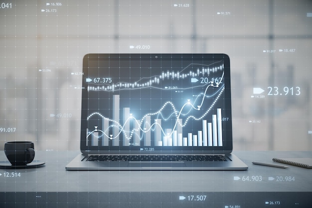 Primer plano de la computadora portátil en el lugar de trabajo con una taza de café y un gráfico o gráfico de forex de velas en una ventana borrosa con fondo de vista de la ciudad Mercado de comercio financiero y concepto de acciones Representación 3D