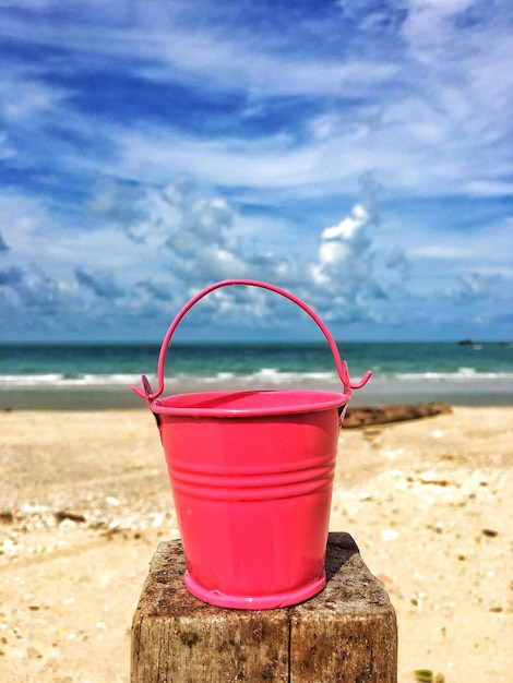 Primer plano de una copa de vino rojo en la playa