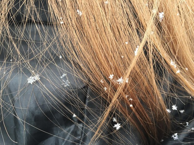 Foto primer plano de copos de nieve en el cabello de una mujer