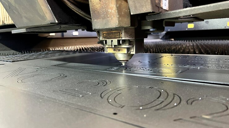 Foto primer plano de una cortadora láser industrial máquina de corte por láser que corta una placa de acero en la fábrica