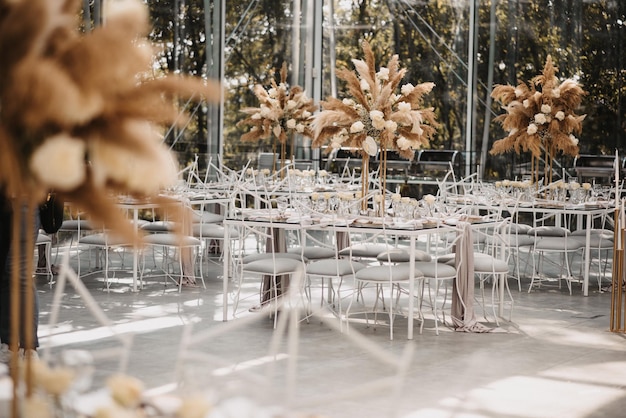 Un primer plano de las elegantes y elegantes mesas de una recepción de bodas al aire libre