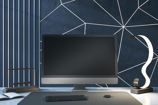 Primer plano del escritorio de diseñador creativo con monitor de computadora negro vacío, varios elementos y pared azul Mock up 3D Rendering