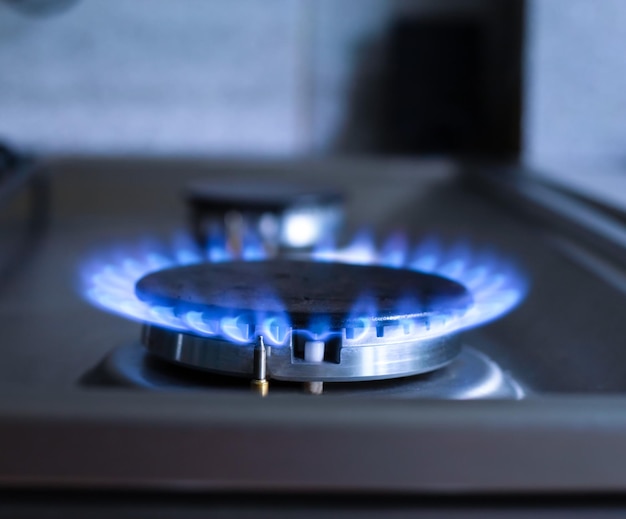 Primer plano de un fuego azul de una estufa de cocina Quemador de gas con un concepto de economía de llama ardiente