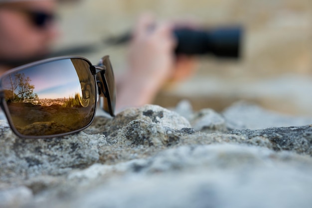 Foto primer plano de gafas de sol en la roca