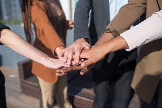 Primer plano de gente de negocios juntando sus manos. Pila de manos. Unidad, trabajo en equipo, concepto de teambuilding