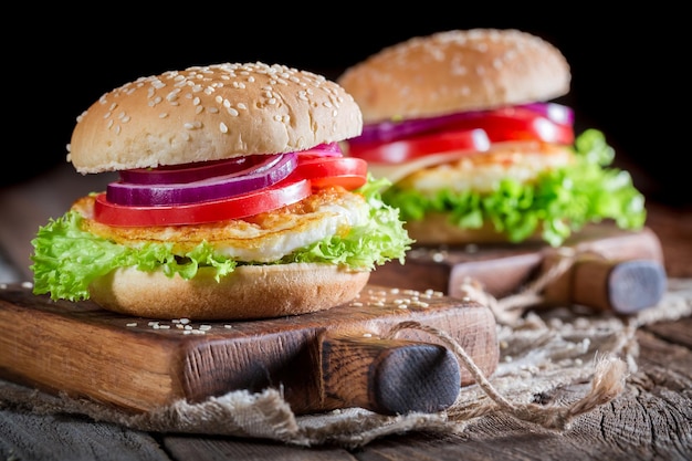 Primer plano de hamburguesa fresca con huevo frito y verduras