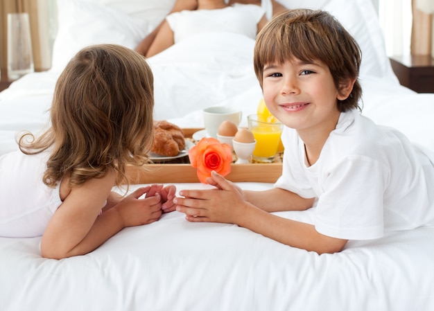 Primer plano de los hermanos que traen el desayuno a sus padres