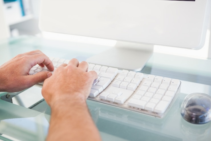 Foto primer plano de un hombre escribiendo en el teclado