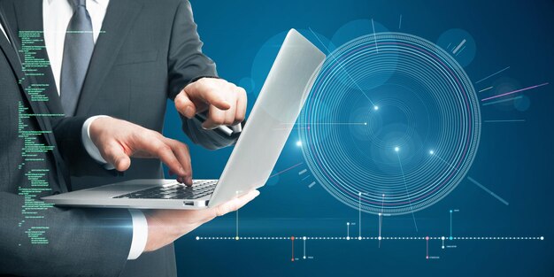 Primer plano de hombres de negocios usando una computadora portátil con interfaz HUD azul futurista y código de programación brillante en un fondo azul borroso Trabajo en equipo de inicio digital futuro y concepto de tecnología
