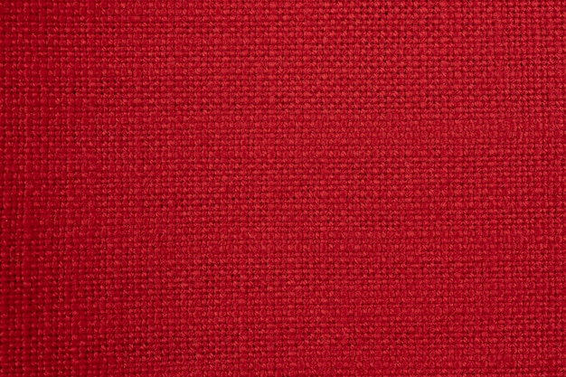 Primer plano macro de material textil de tela roja como fondo de textura